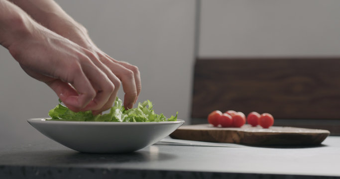 add frisee salad leaves into white bowl