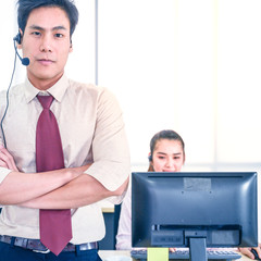 Young customer service men agent with headsets and computer working at office.