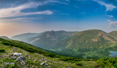 Naklejka premium Panoramic landscape view on lake in the valley between mountain range during sunset in wild taiga, Siberia, Russia
