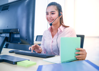 Young customer service women agent with headsets and computer working at office.