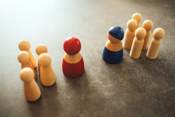 Two different groups of people standing facing to each other for equality and competition in business concept