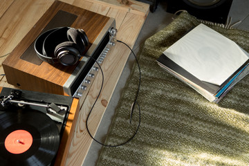 HiFi system with turntable, amplifier, headphones and lp vinyl records in a listening room