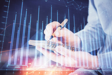 Double exposure hands with stock market chart.