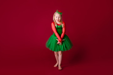 Kid dancer satisfied with concert outfit. Kids fashion. Kid fashionable green dress looks adorable. Clothes for ballroom dance. Ballroom dancewear fashion concept.