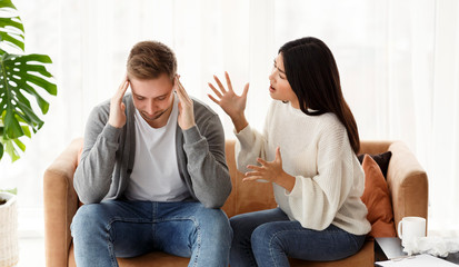 Fototapeta na wymiar Asian Wife Blaming Cheating Husband Sitting In Marital Therapist's Office