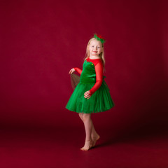 Kid dancer satisfied with concert outfit. Kids fashion. Kid fashionable green dress looks adorable. Clothes for ballroom dance. Ballroom dancewear fashion concept.