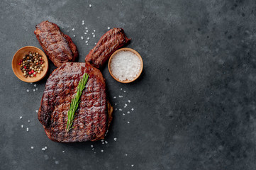 Grilled Easter steak with spices. Easter bunny on stone background with copy space for your text.
