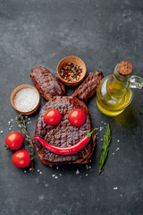Grilled Easter steak with spices. Easter bunny on stone background with copy space for your text.
