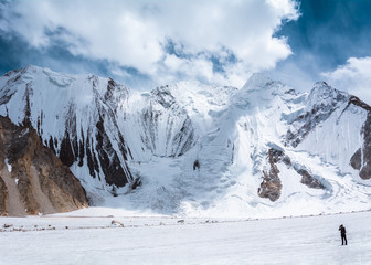 View of trekker taking a photo of Vigne Mountain Range from the way to Ali camp, Pakistan