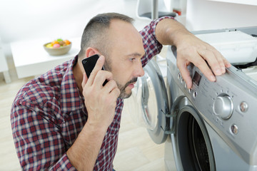 husband man doing laundry at home