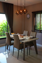 dish ware sets arrange on dining table inside eating room of modern home interior