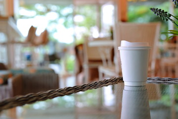 take away cup for hot coffee drink put on glass table in cafe shop