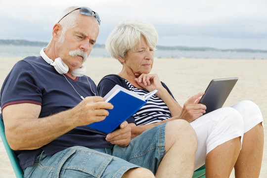 seniors reading on the beach