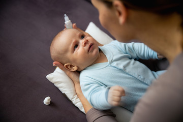 Top view of young lady treating little child at home