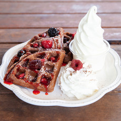 Chocolate waffle with mix berries and soft serve ice cream