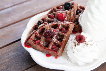 Chocolate waffle with mix berries and soft serve ice cream