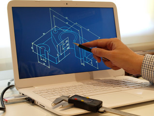 engineer working on mechanical piece design using a laptop computer device