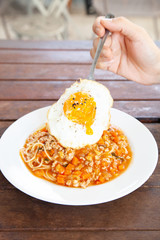 Italian spaghetti bolognese with tomato sauce and fried egg