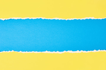 Torn ripped paper edge with a copy space, color blue and yellow background