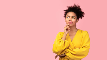 Portrait of afro girl looking up at studio