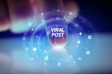 Finger touching tablet with social media icons and VIRAL POST