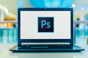 Laptop computer displaying logo of Adobe Photoshop