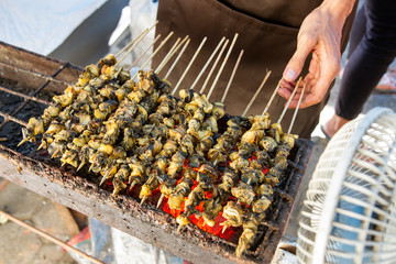 sate keong or snail satay is traditional typical indonesian food © Ibenk.88