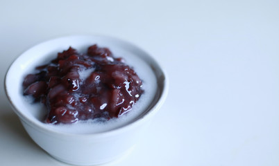 Black glutinous rice porridge or bubur ketan hitam with coconut milk. Indonesian sweet dessert. 