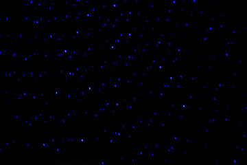 Neon lights in a disco. Isolated on black background, glare. night view, neon light, rays. Celebratory background. star Rain.