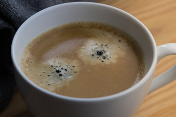 Texture of coffee in a cup visible bubbles closeup shot