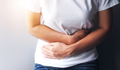Asian women suffering with severe stomach pain, Stomach ache or menstrual pain.