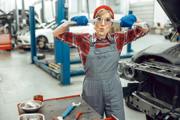 Caucasian girl holding a pair of spanners