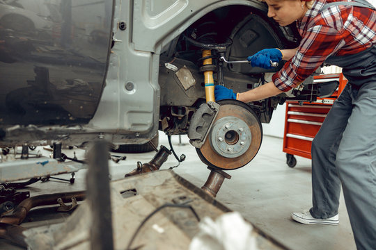 Young Female Mechanic Using A Box Spanner