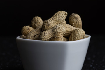 Peanuts in closeup a delicious healthy snack dark background