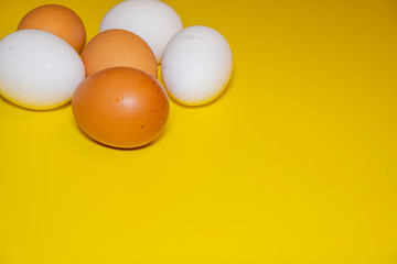 White and brown Easter eggs bright yellow background. Concept happy Easter. Minimalism concept. Top view.