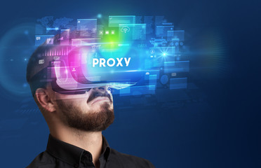 Businessman looking through Virtual Reality glasses with PROXY inscription, innovative security concept