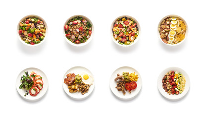 Top view of different salads on white background