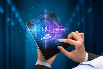 Businessman holding a foldable smartphone with WEB DESIGN inscription, new technology concept DEEP...