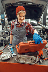 Smiling girl staring at a tool kit