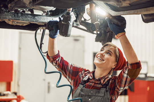 Woman Holding A Flashlight And An Impact Wrench