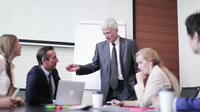 Business man speaking on seminar , whiteboard or flipchart on background