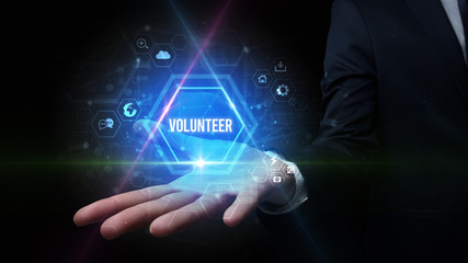 Man hand holding VOLUNTEER inscription, social media concept