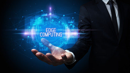 Man hand holding EDGE COMPUTING inscription, technology concept