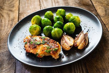Roast chicken breast and on wooden background 
