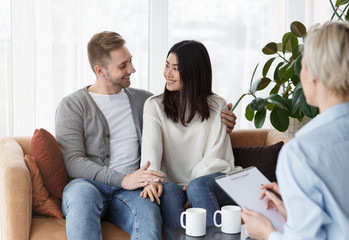 Happy Couple Hugging In Family Counselor Office After Reconciliation