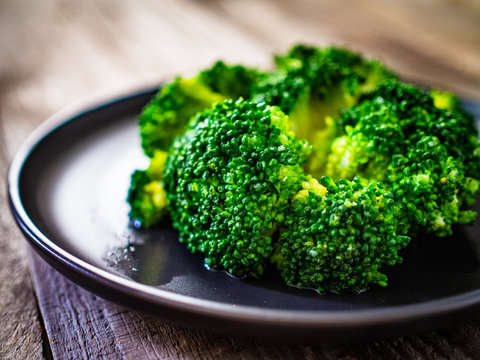 Boiled broccoli on wooden table