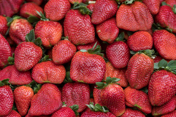 A stack of red and ripe strawberries, background. The Jerusalem Market