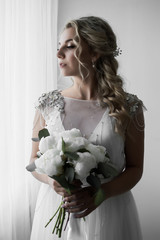 bride with a bouquet in her hands on the wedding day. wedding ceremony. selective focus. film grain.