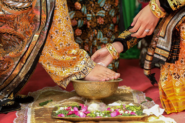 Injak Telur Ceremony in Javanese wedding. Groom breaks an egg using foot, signifies that he's ready...