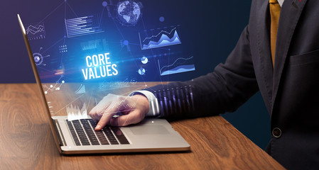 Businessman working on laptop with CORE VALUES inscription, new business concept